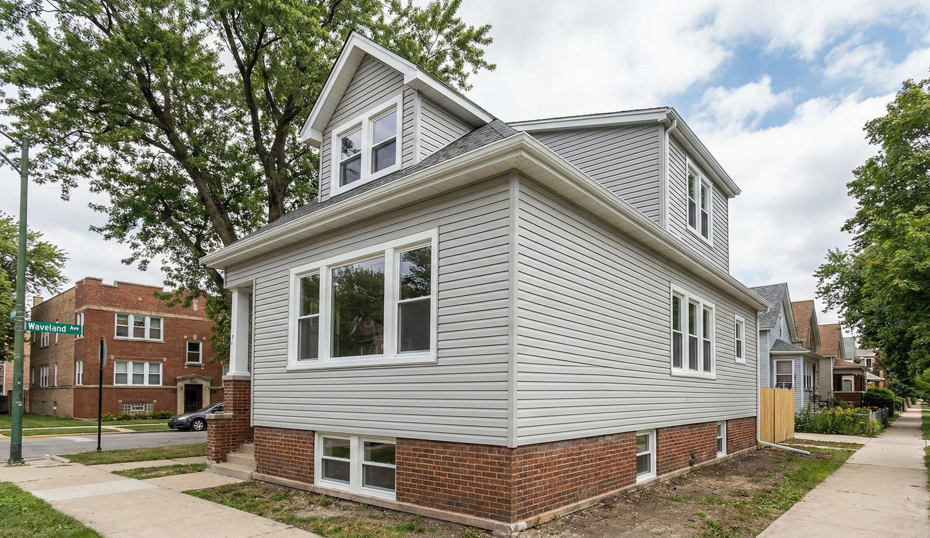 Brown roof with matching gutter and downspout, against a blue sky with yellow leaves.