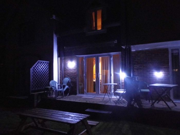 Albion Cottage outside patio being lit by solar powered lights
