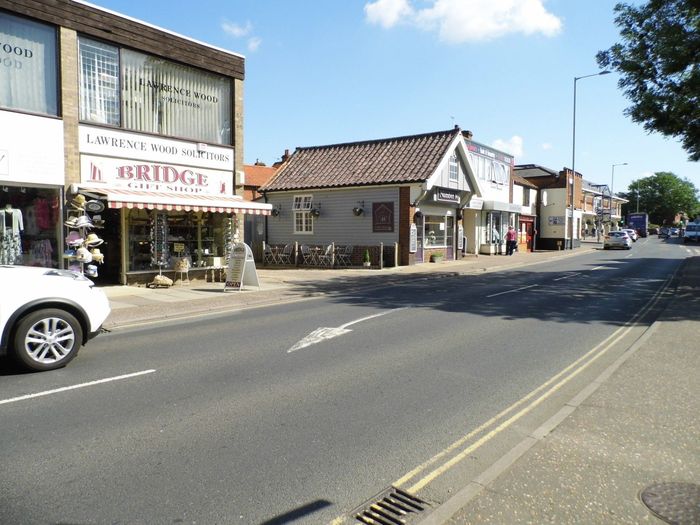 Souvenir, gift, and take-away shops on High St. Wroxham, Norfolk.