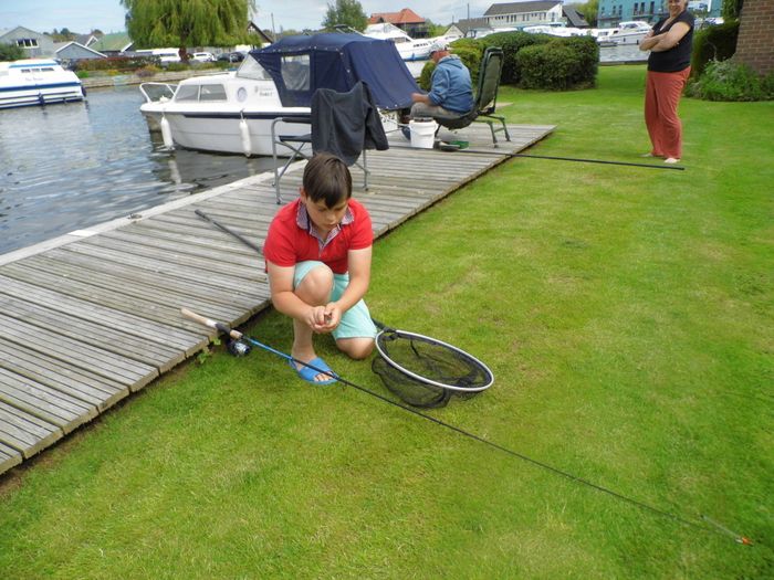 Young boy preparing to start fishing on River Bure.