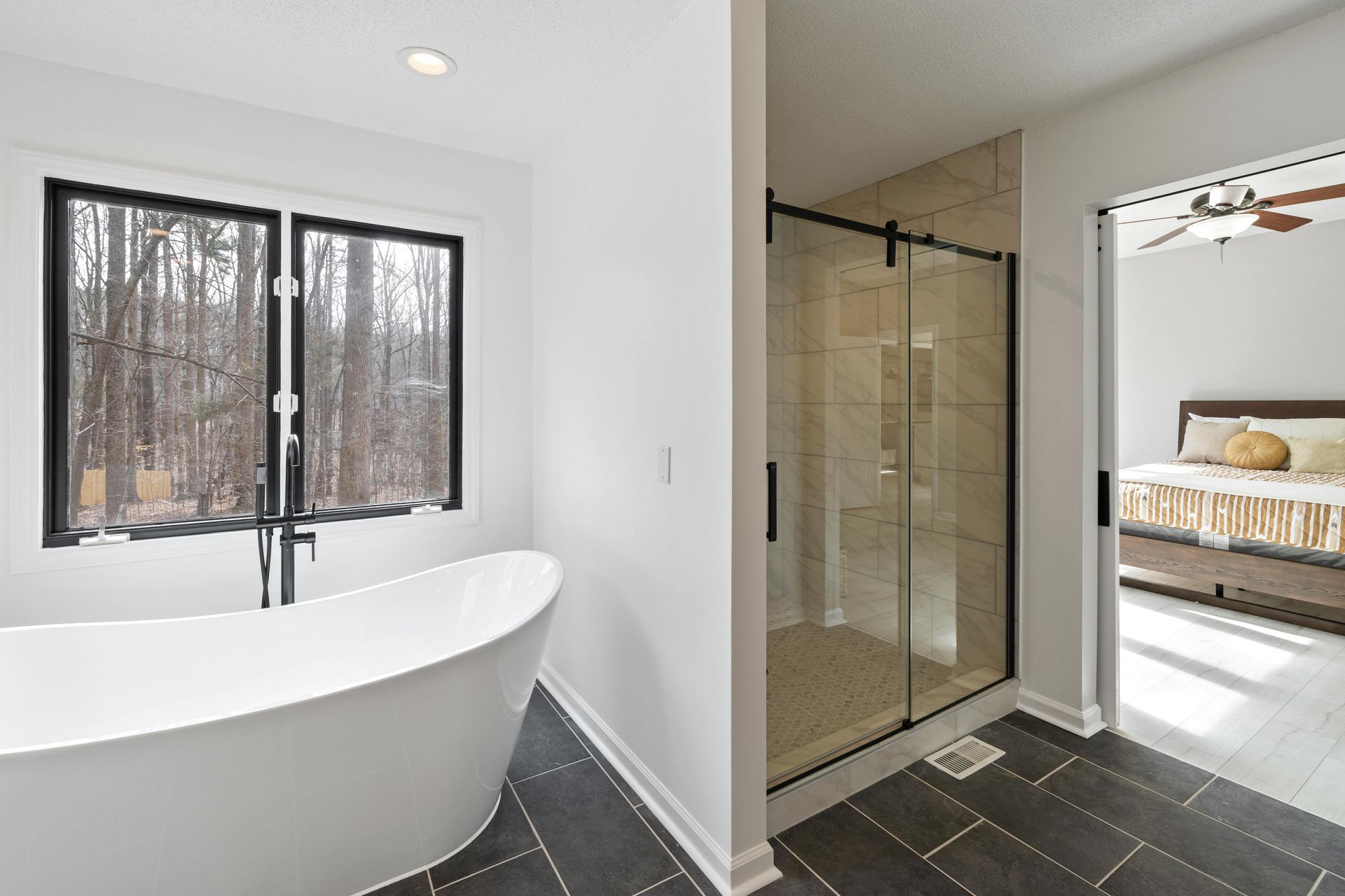 A bathroom with a black and white tile floor and a sink.