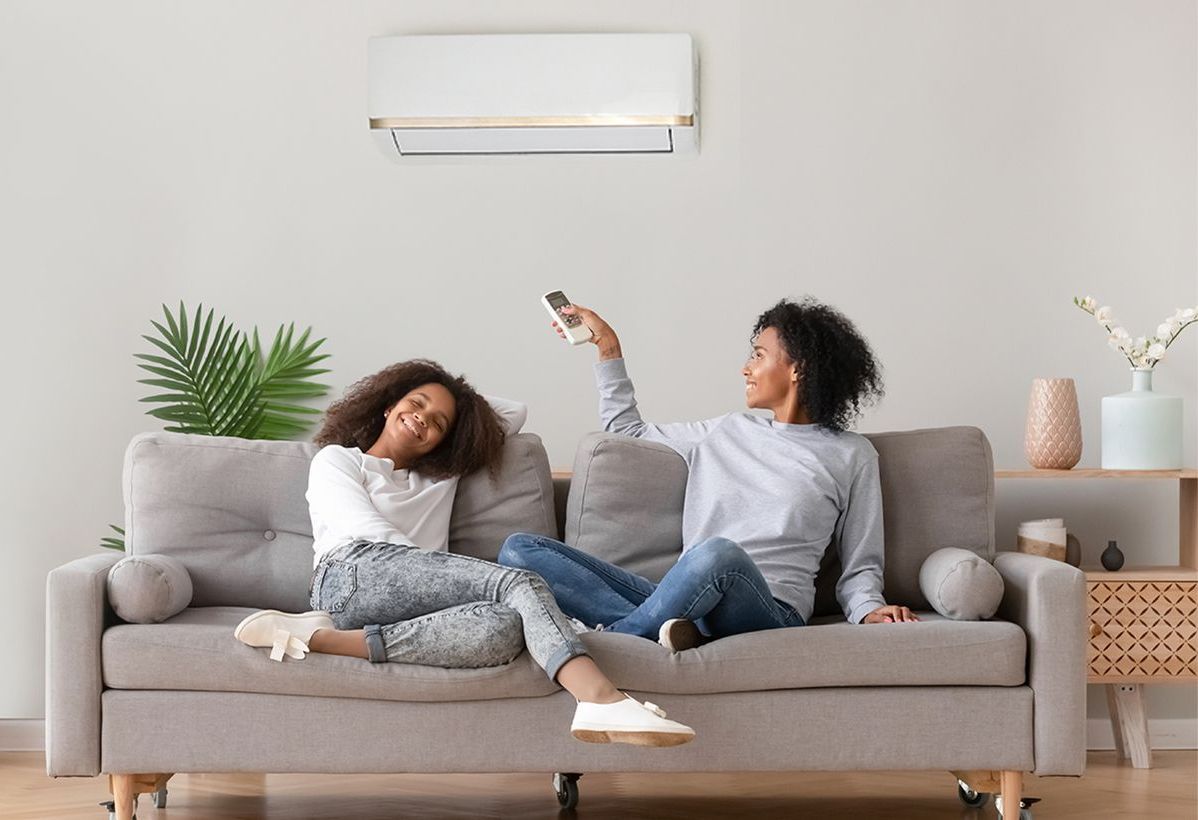 A house with a porch and a couch in front of it.