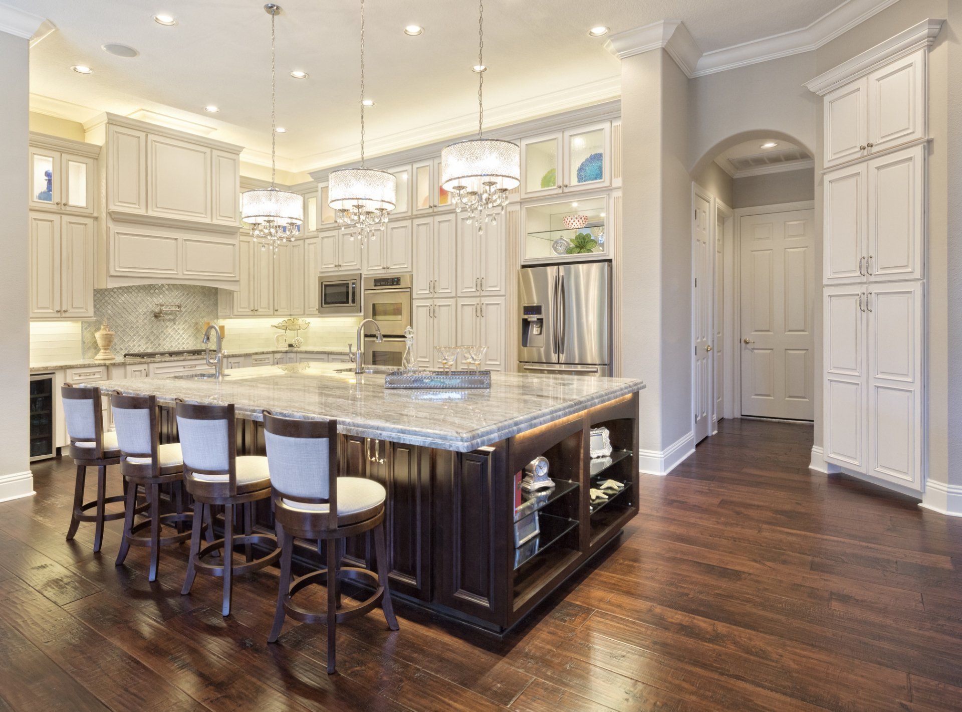 A large kitchen with a large island and stools.