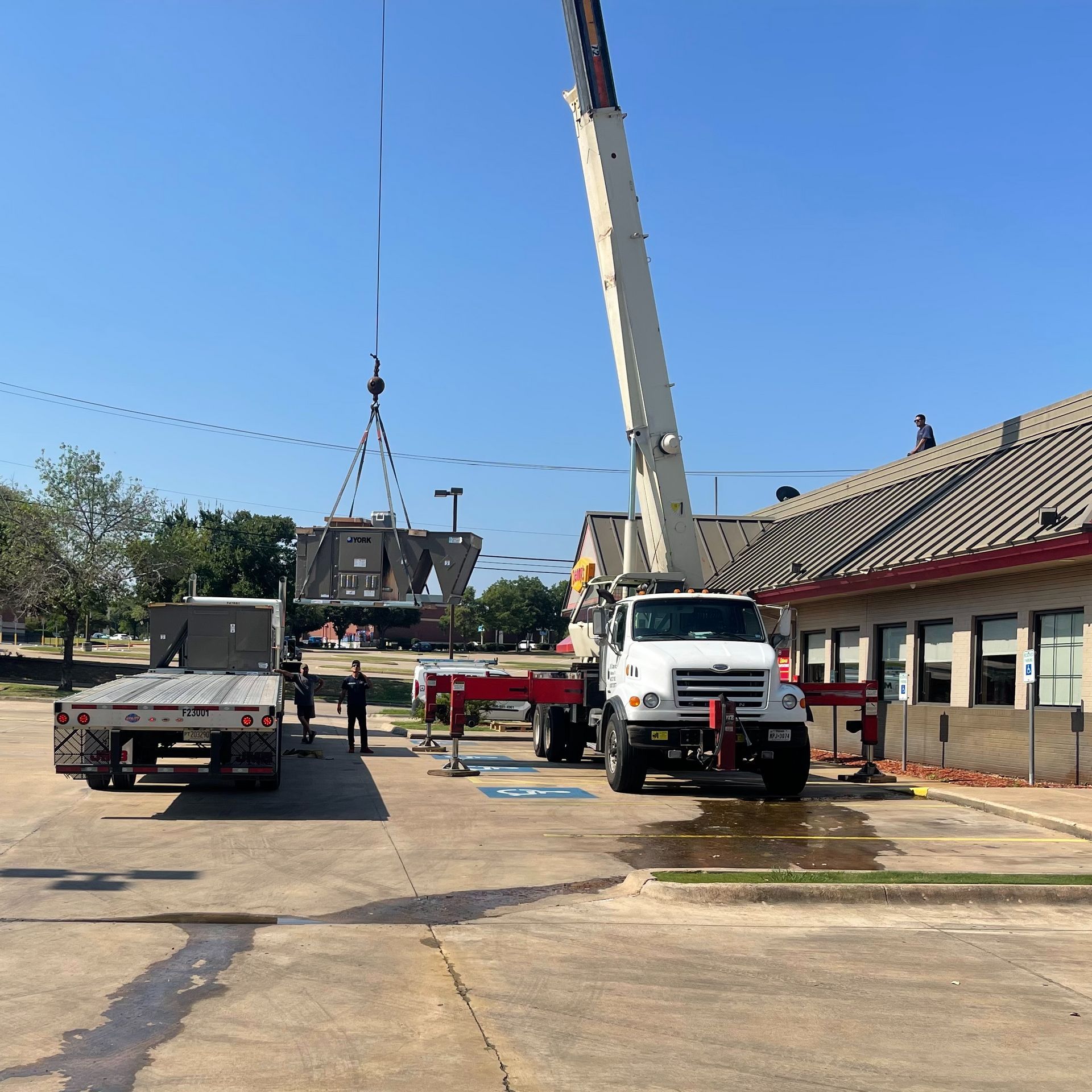 A truck with a crane attached to the back of it