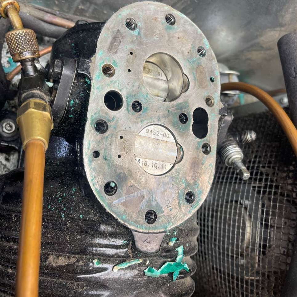 A close up of a carburetor on a motorcycle engine.