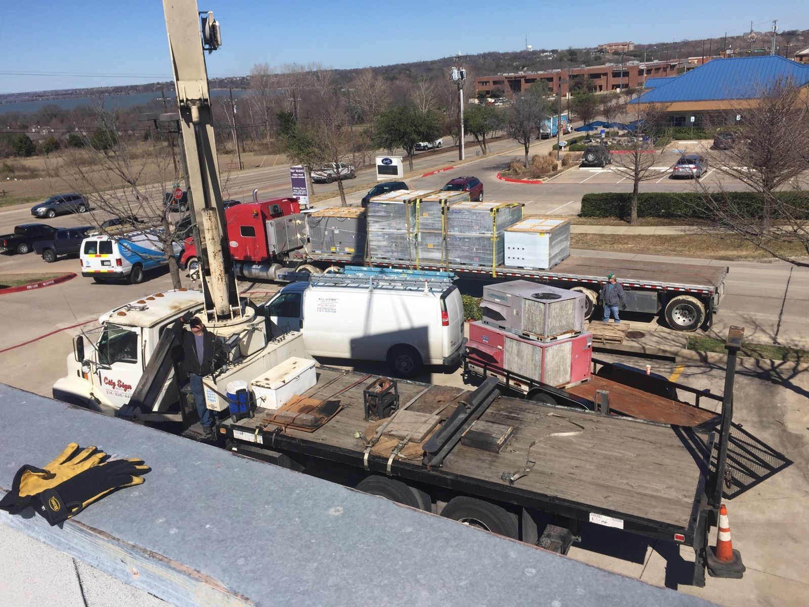 A large truck with a crane on top of it is parked in a parking lot.