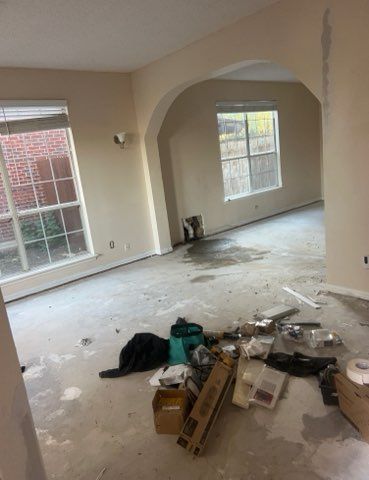 An empty living room with a lot of boxes on the floor.