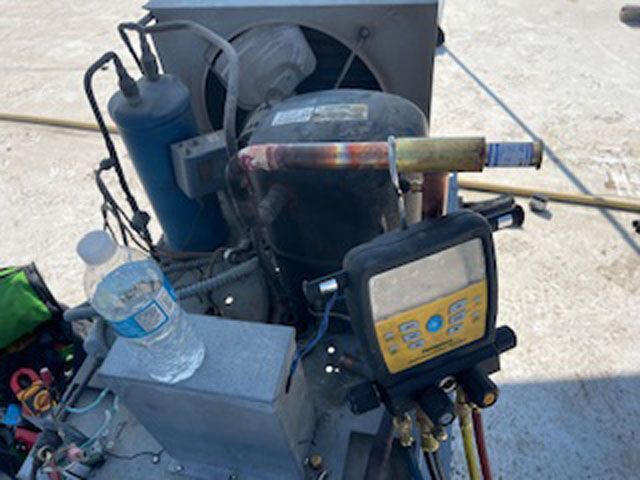 A bottle of water is sitting on a table next to a machine.