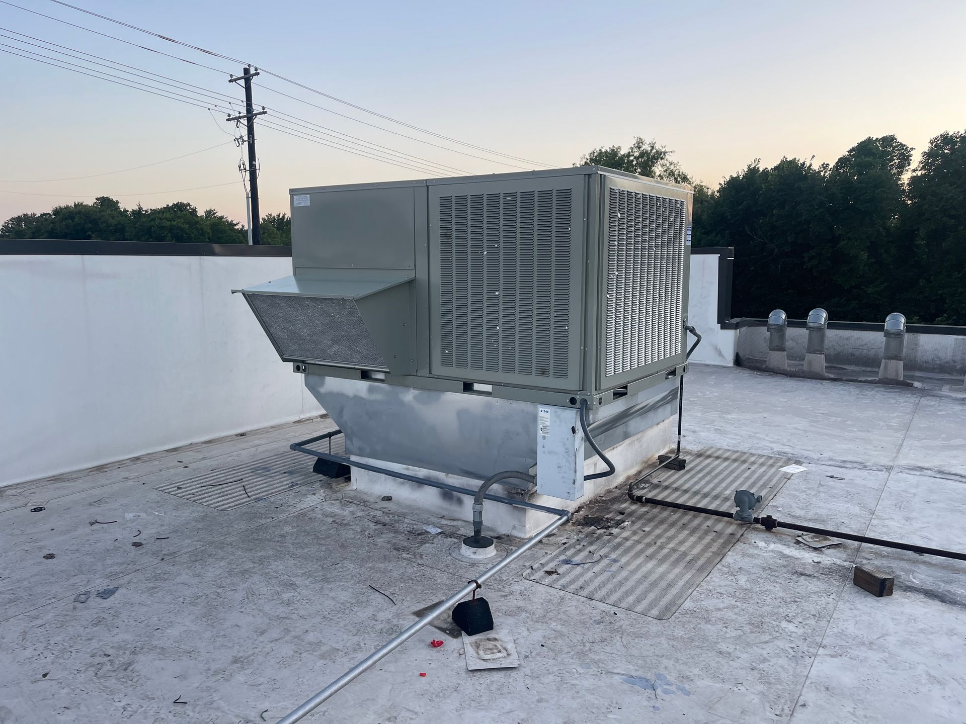 A large air conditioner is sitting on top of a roof.