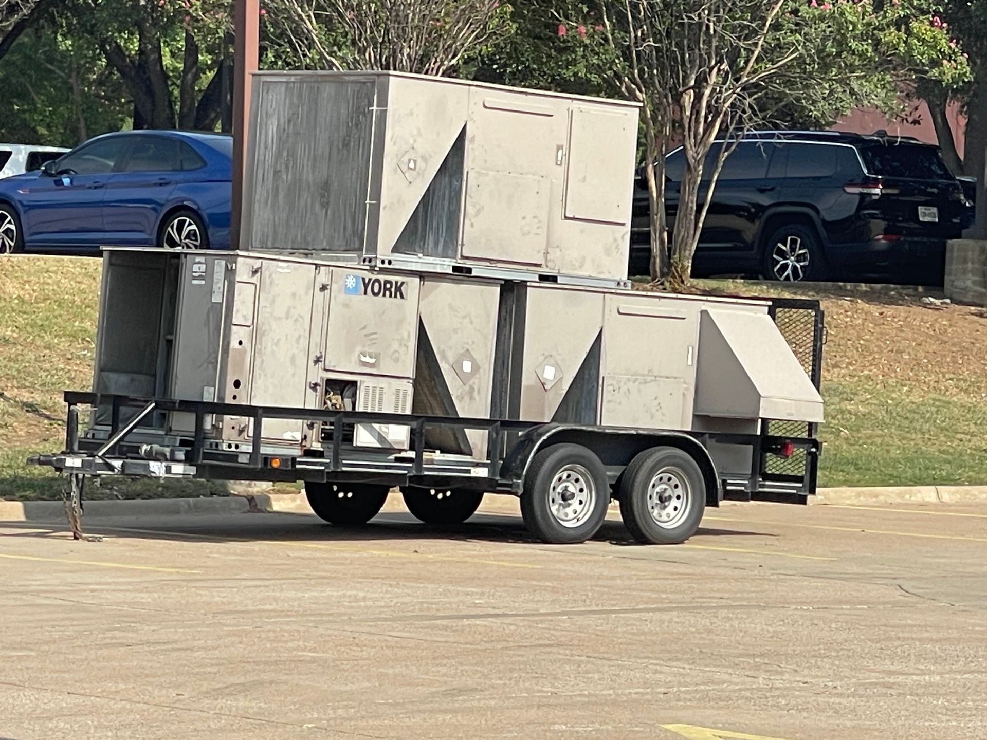 A trailer with a bunch of boxes on it is parked in a parking lot.