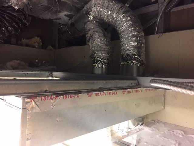 A hose is hanging from the ceiling of a building.