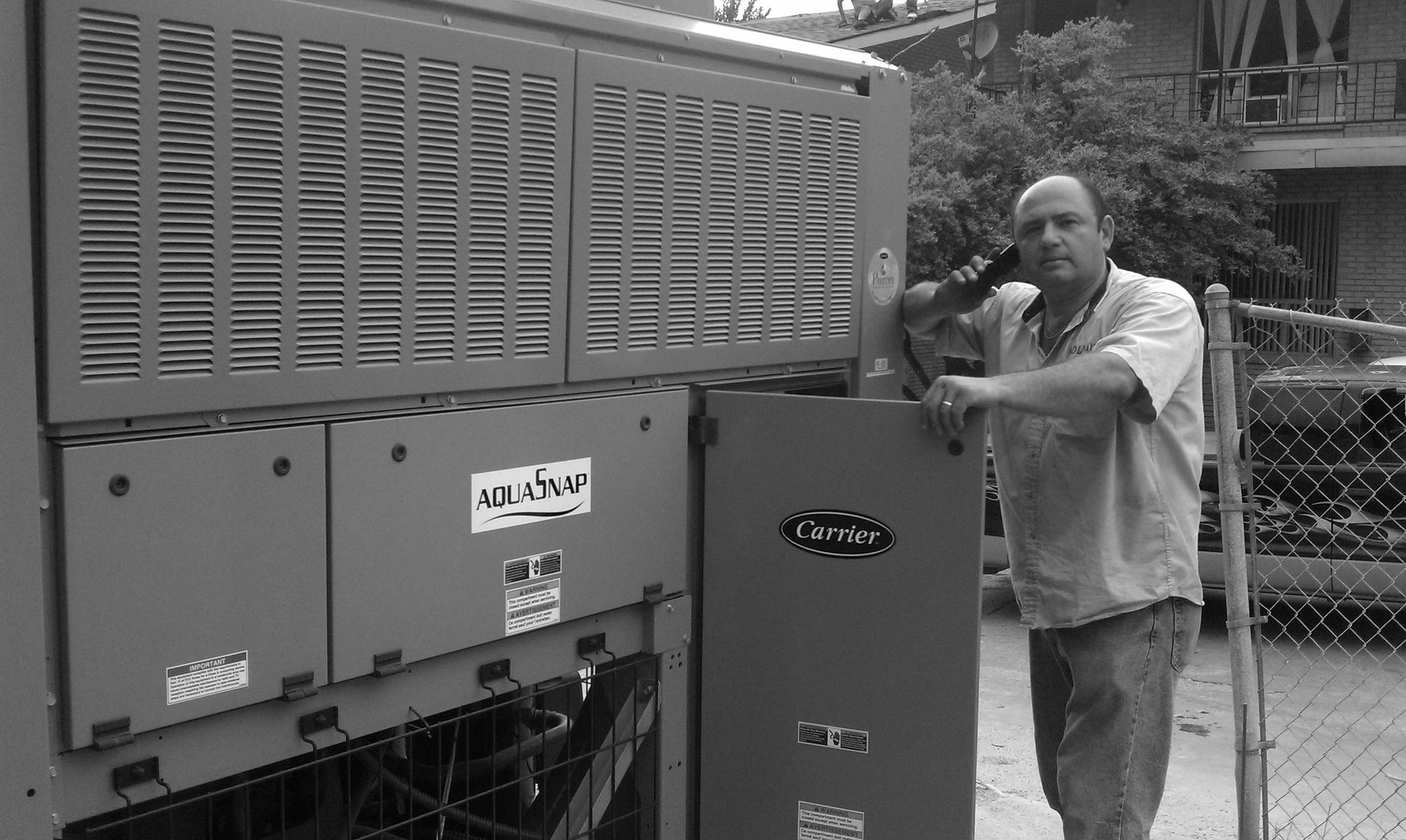 A man is standing in front of a large machine.