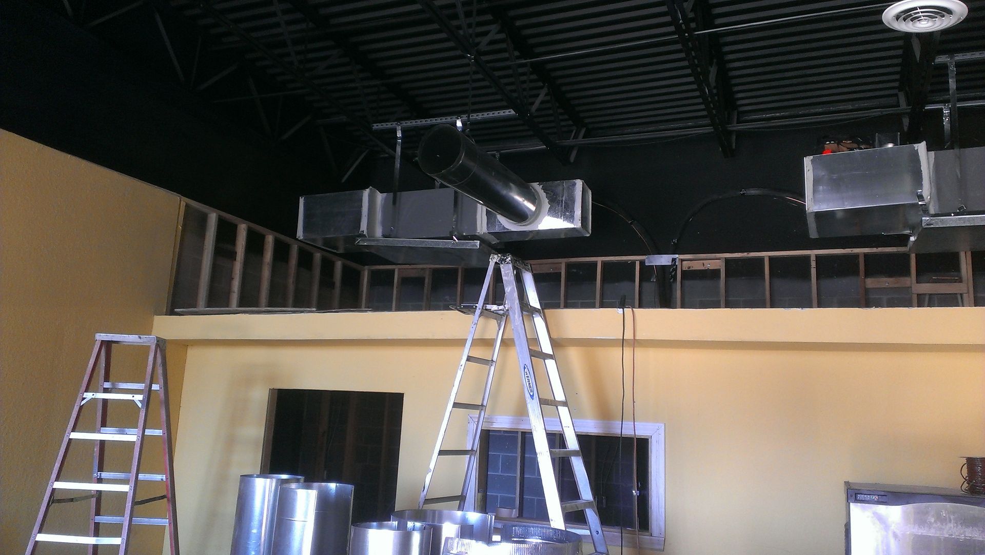 A ladder is hanging from the ceiling of a building