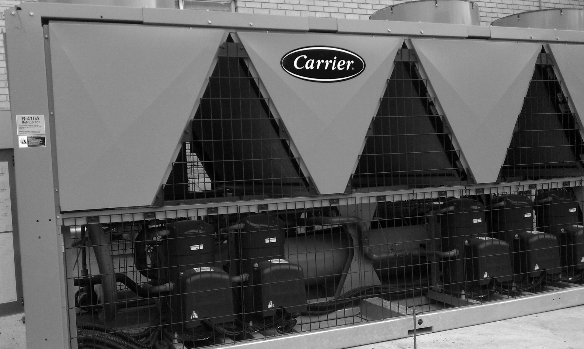 A black and white photo of a carrier air conditioner.