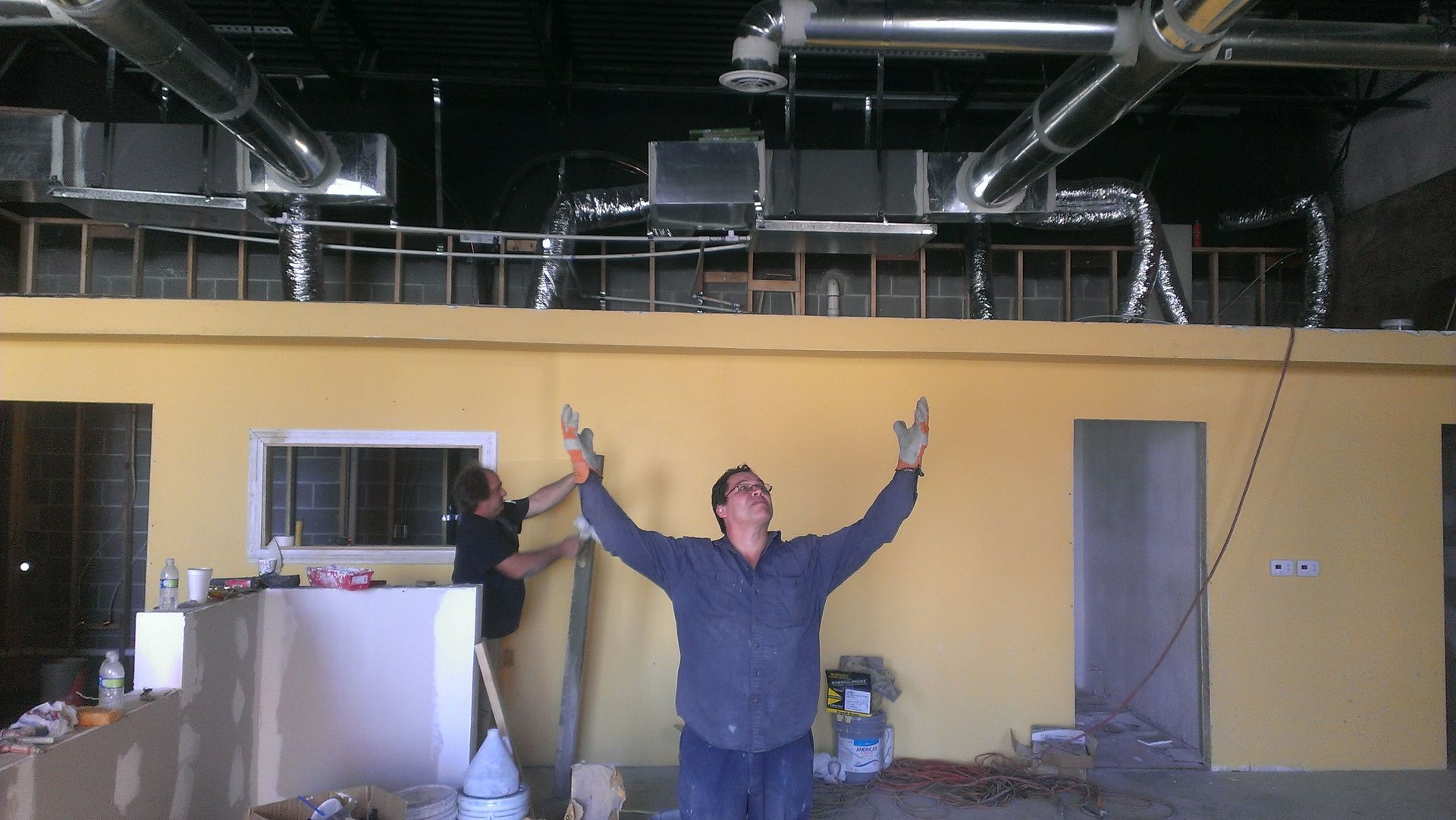 A man standing in a room with his arms outstretched