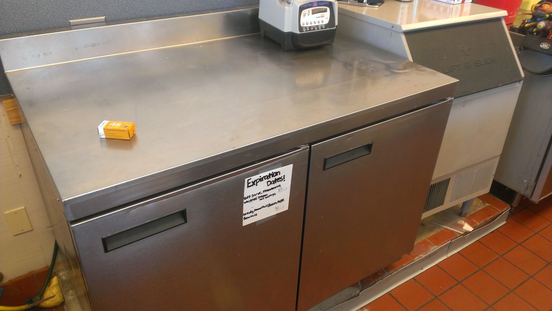 A stainless steel counter refrigerator