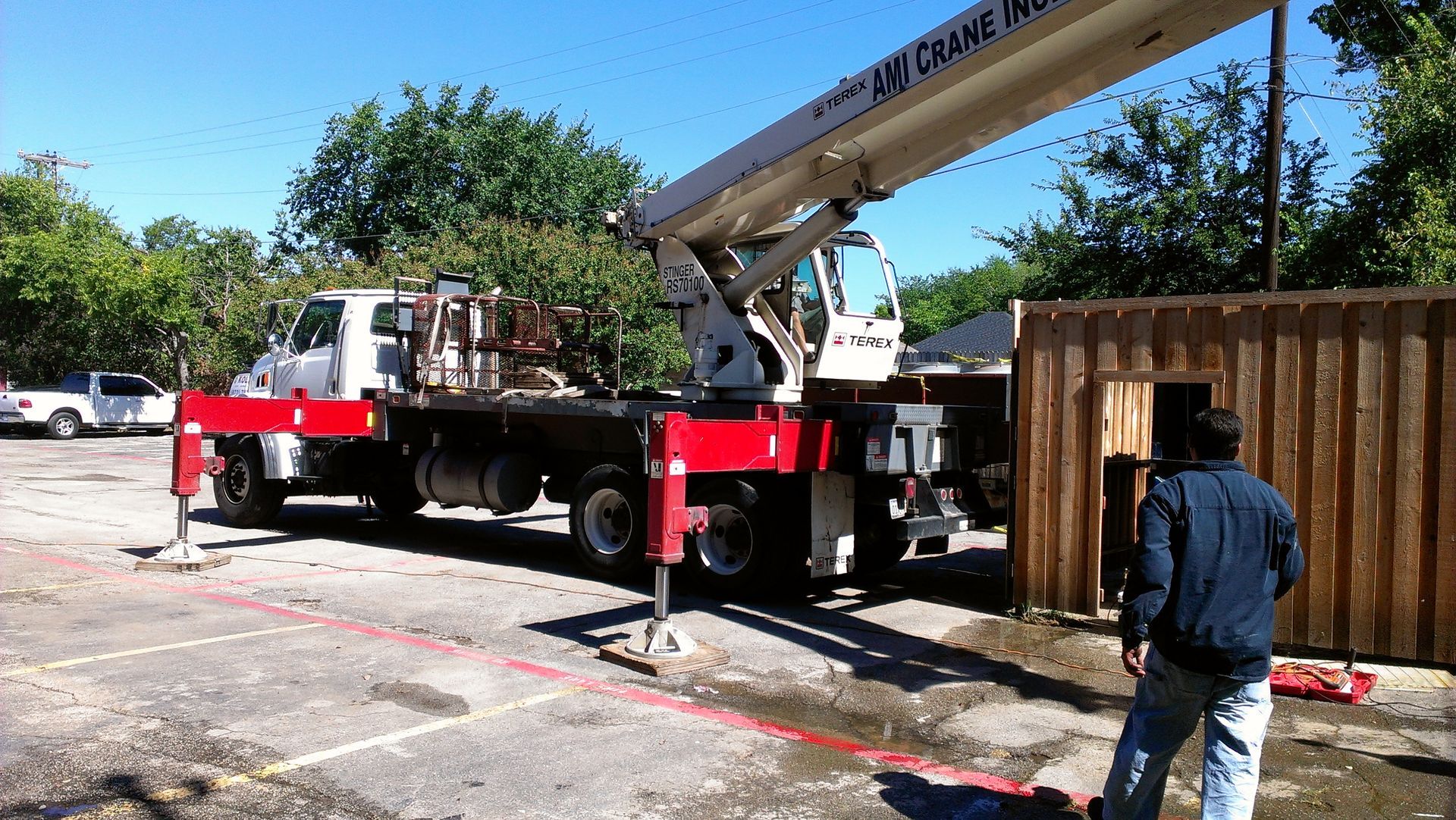 A man standing next to a crane