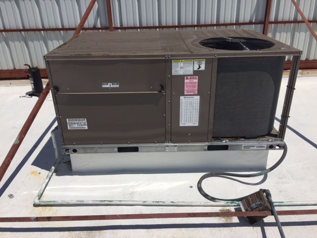 An air conditioner is sitting on the roof of a building