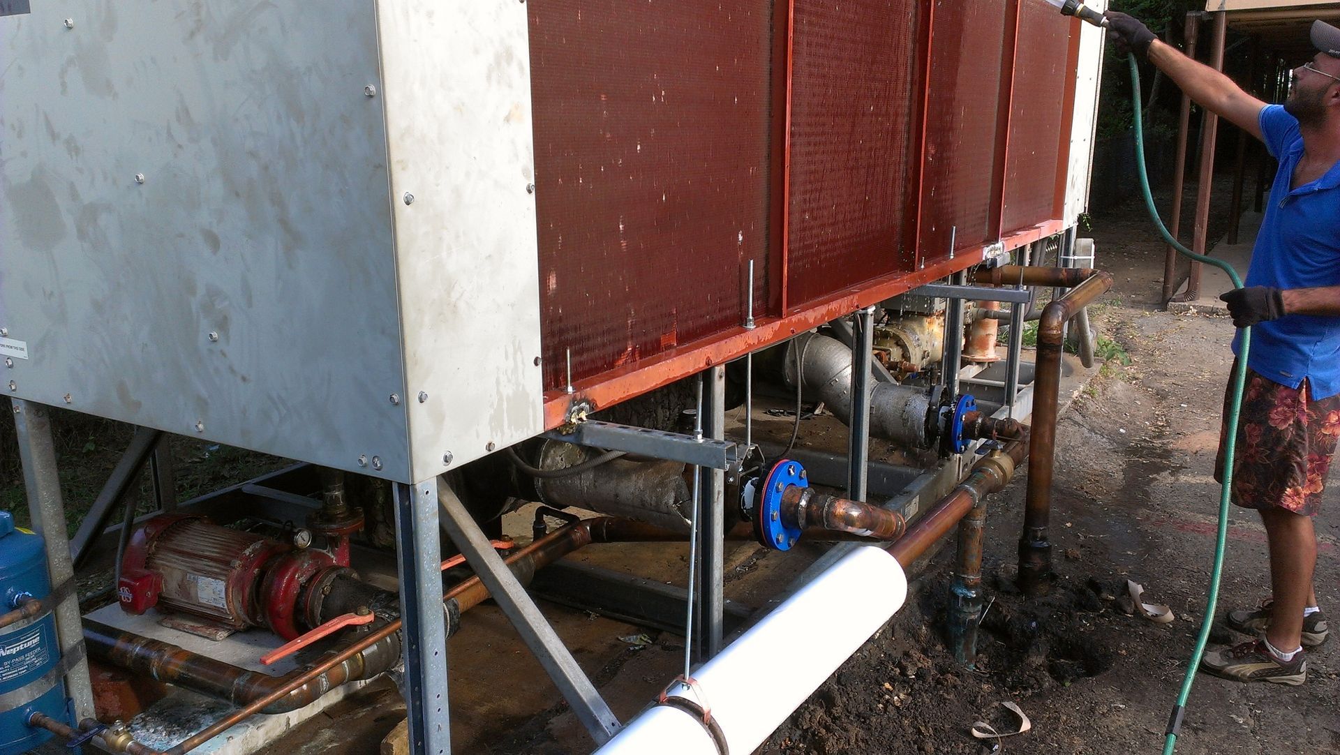 A man in a blue shirt is working on a machine