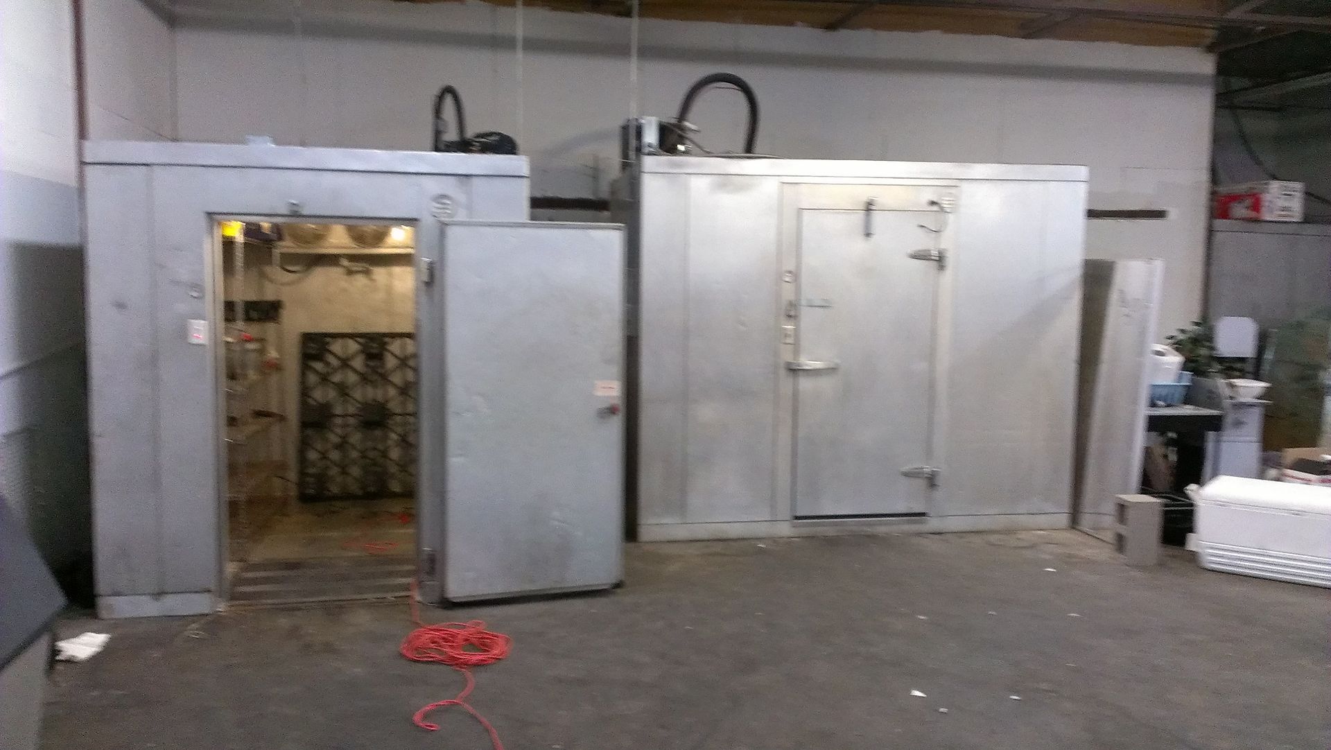 A large room with a lot of restaurant kitchen cooler doors.