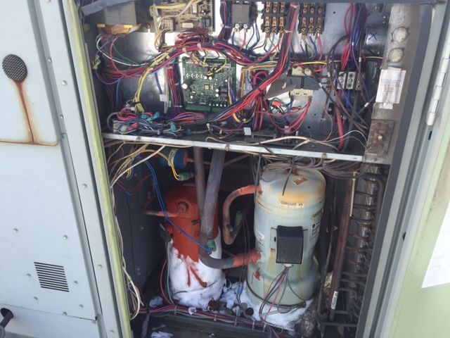 The inside of a machine with a lot of wires coming out of it