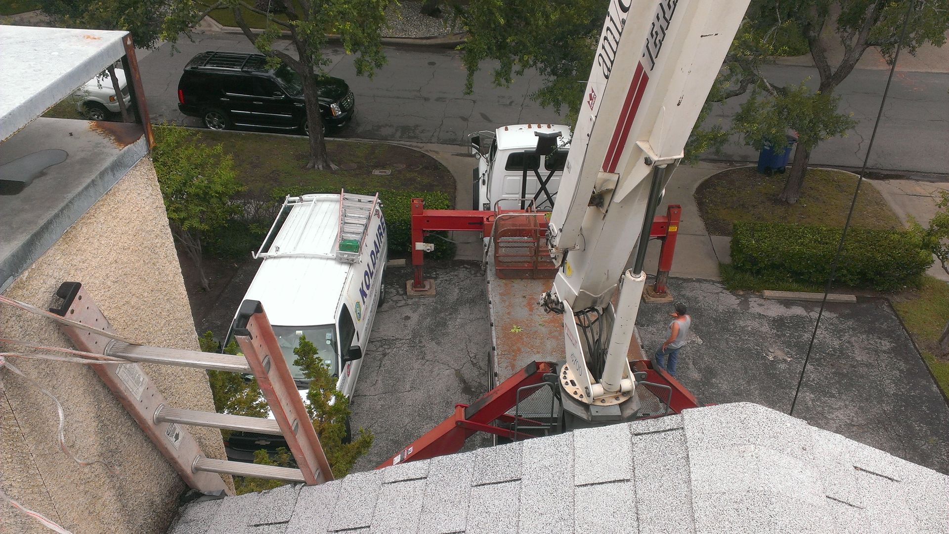 An aerial view of a crane on top of a building