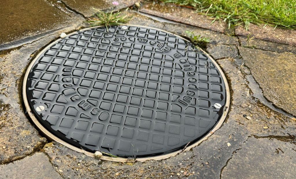 manhole in garden path.