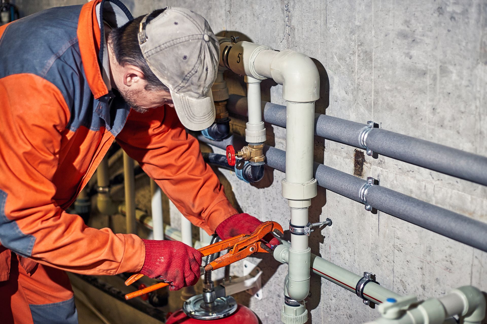 The plumber worker repairs the heating system. 