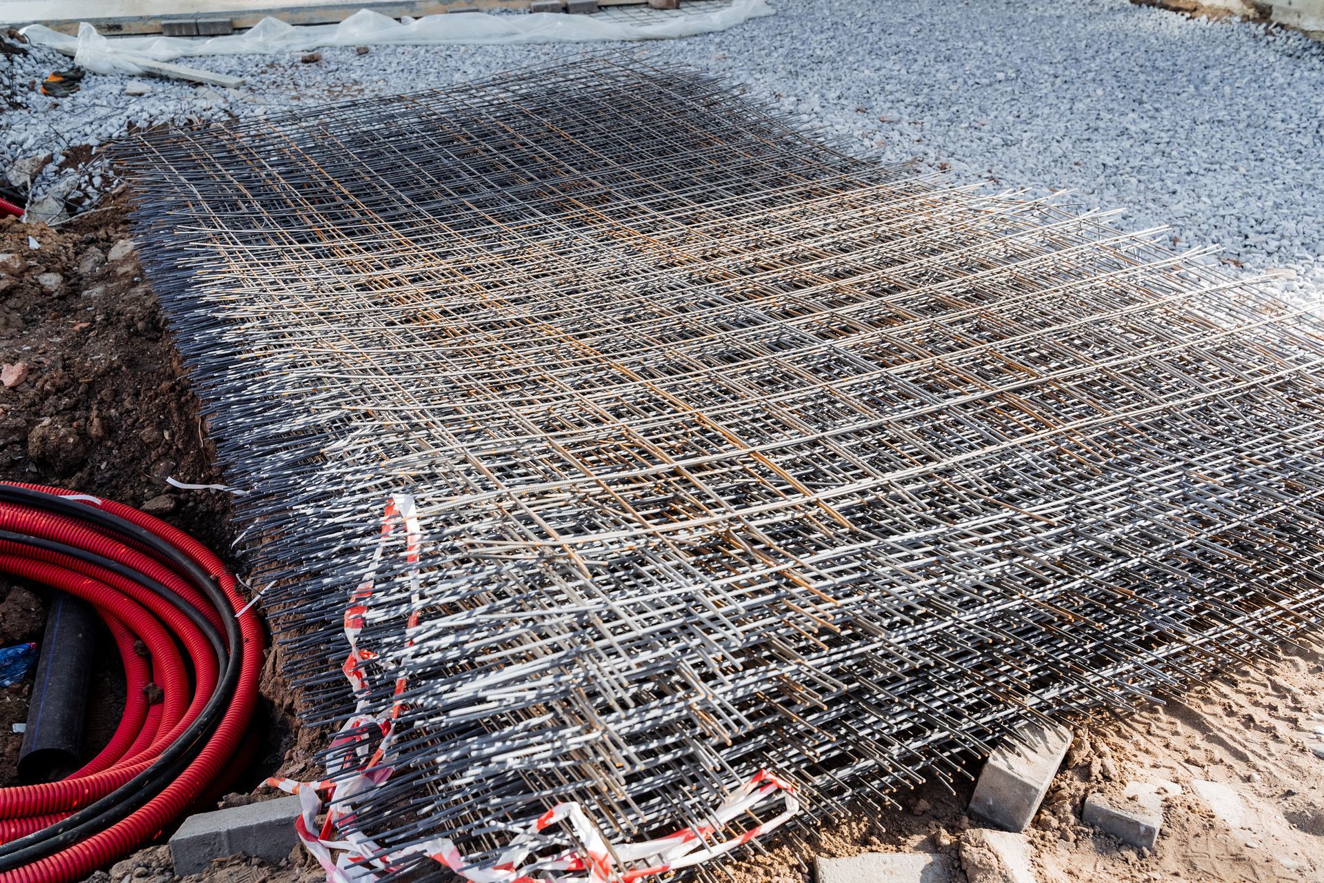 Wire mesh stacked on dirt pile for construction project.