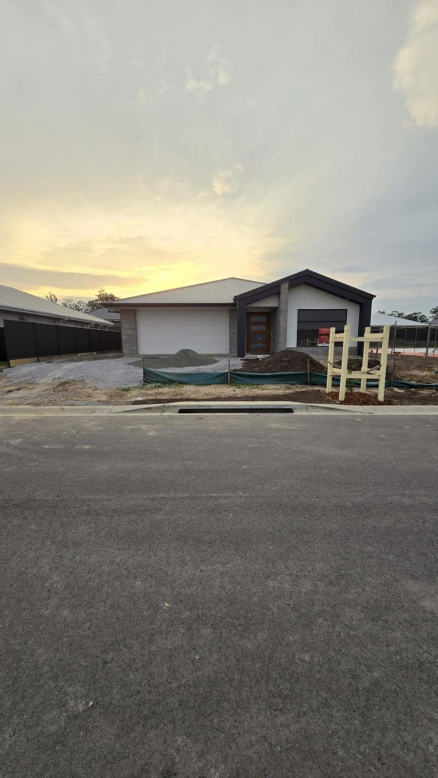 Small Modern House at Dusk With a Paved Road — Edmonds Turf in Louth Park, NSW