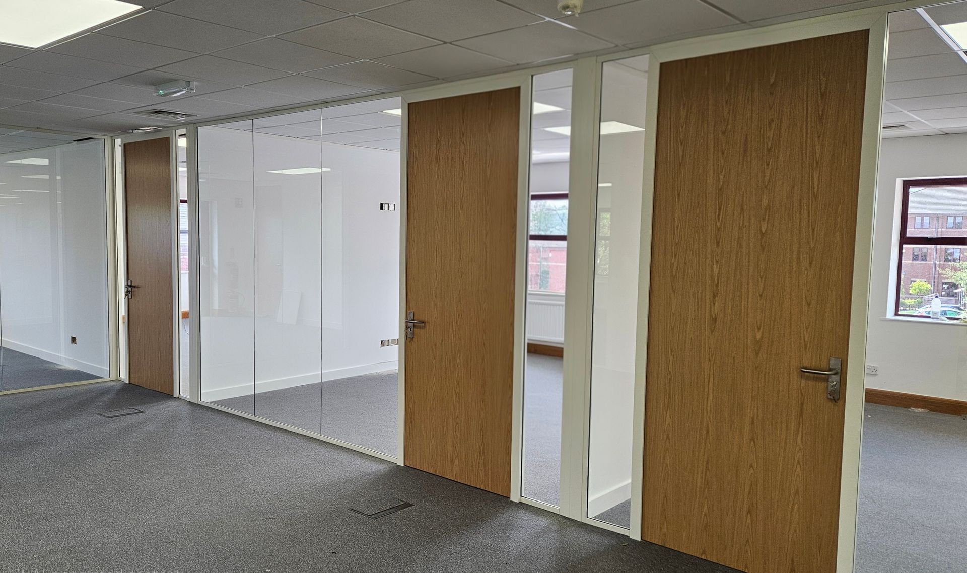 Frameless single glazed office glass partitions in Sunderland with timber doors