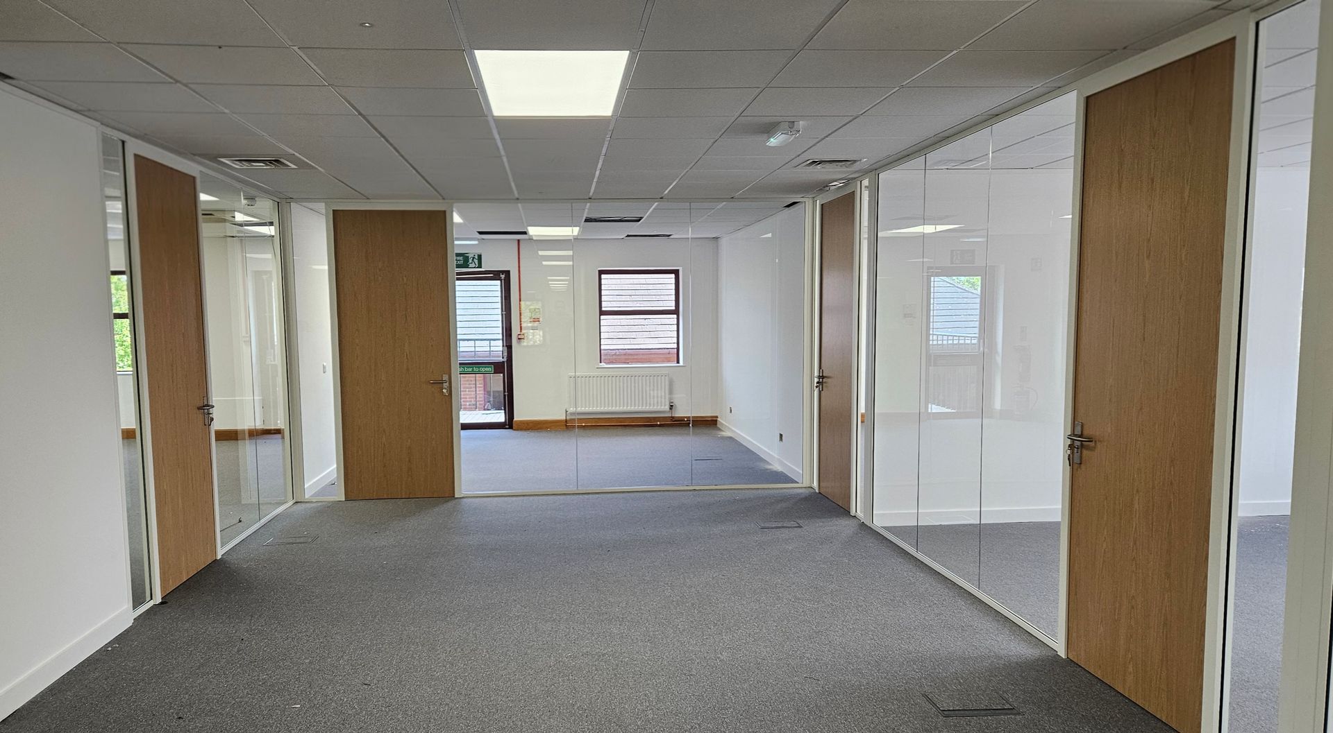 Frameless single glazed office glass partitions in Sunderland with timber doors