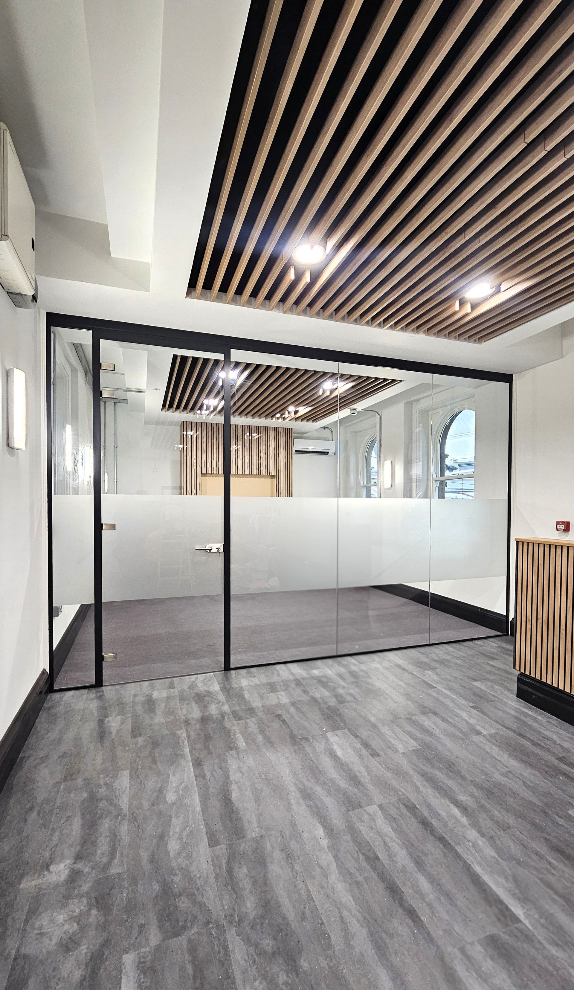 Single glazed glass partition with glass door installed at Newcastle Central Station