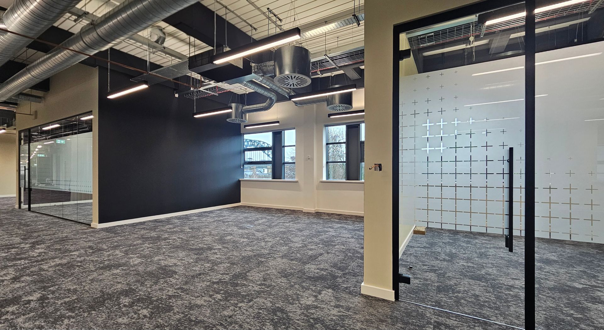 Glass office partitions with Tyne Bridge views