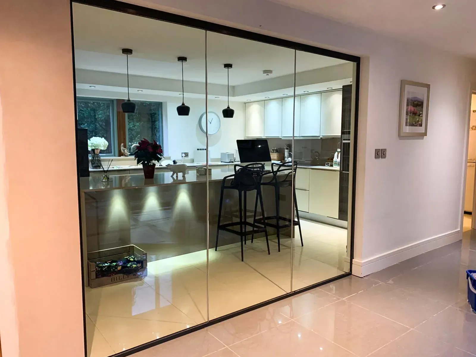 Stunning E30 30/0 Fire Rated Frameless Glass Screen in a Home Kitchen. Enhancing the sense of space while allowing natural light to pour in.