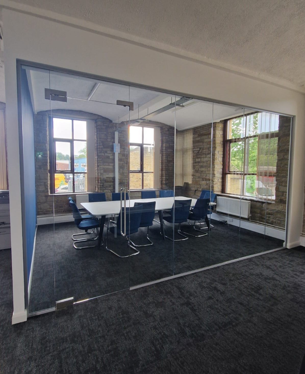 Frameless Single Glazed Glass Partition with Glass Door & Glass Overpanel for a boardroom near Leeds