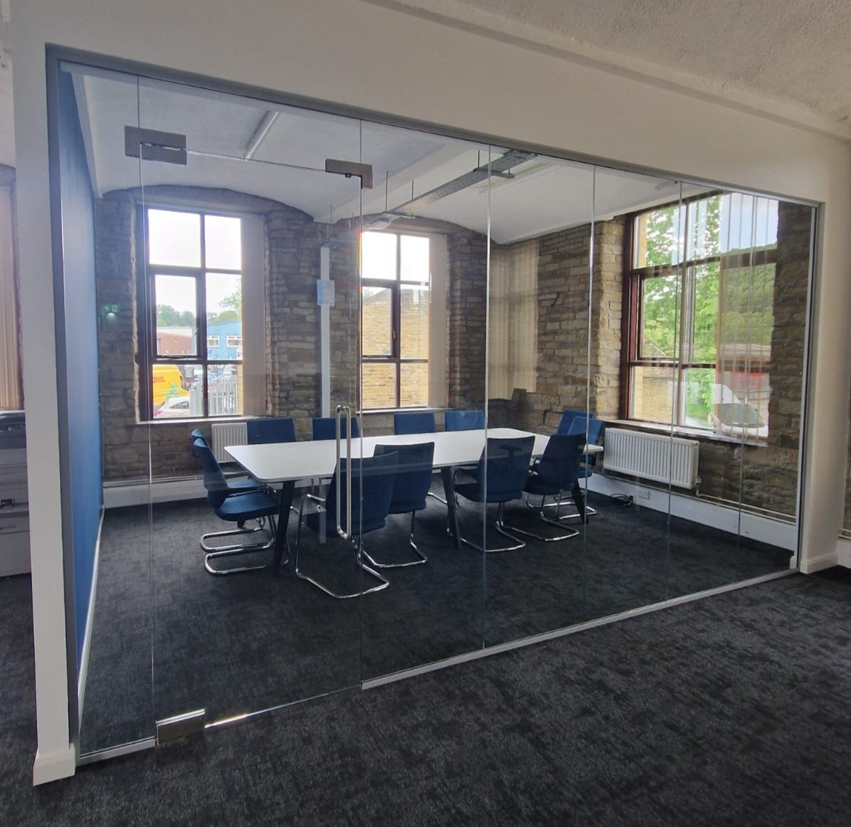 Frameless Single Glazed Glass Partition with Glass Door & Glass Overpanel for a boardroom near Leeds