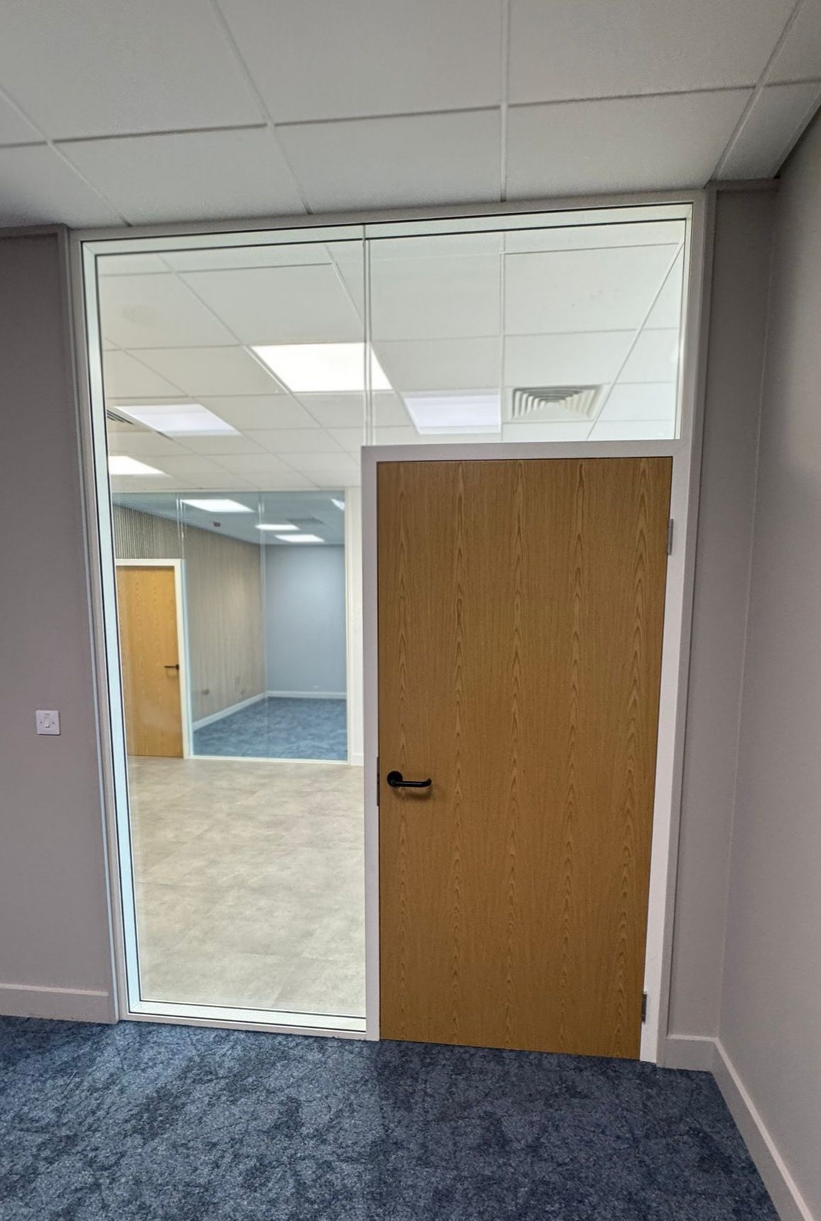 Modern glass partitioning system with acoustic performance and timber doors in Stockton office