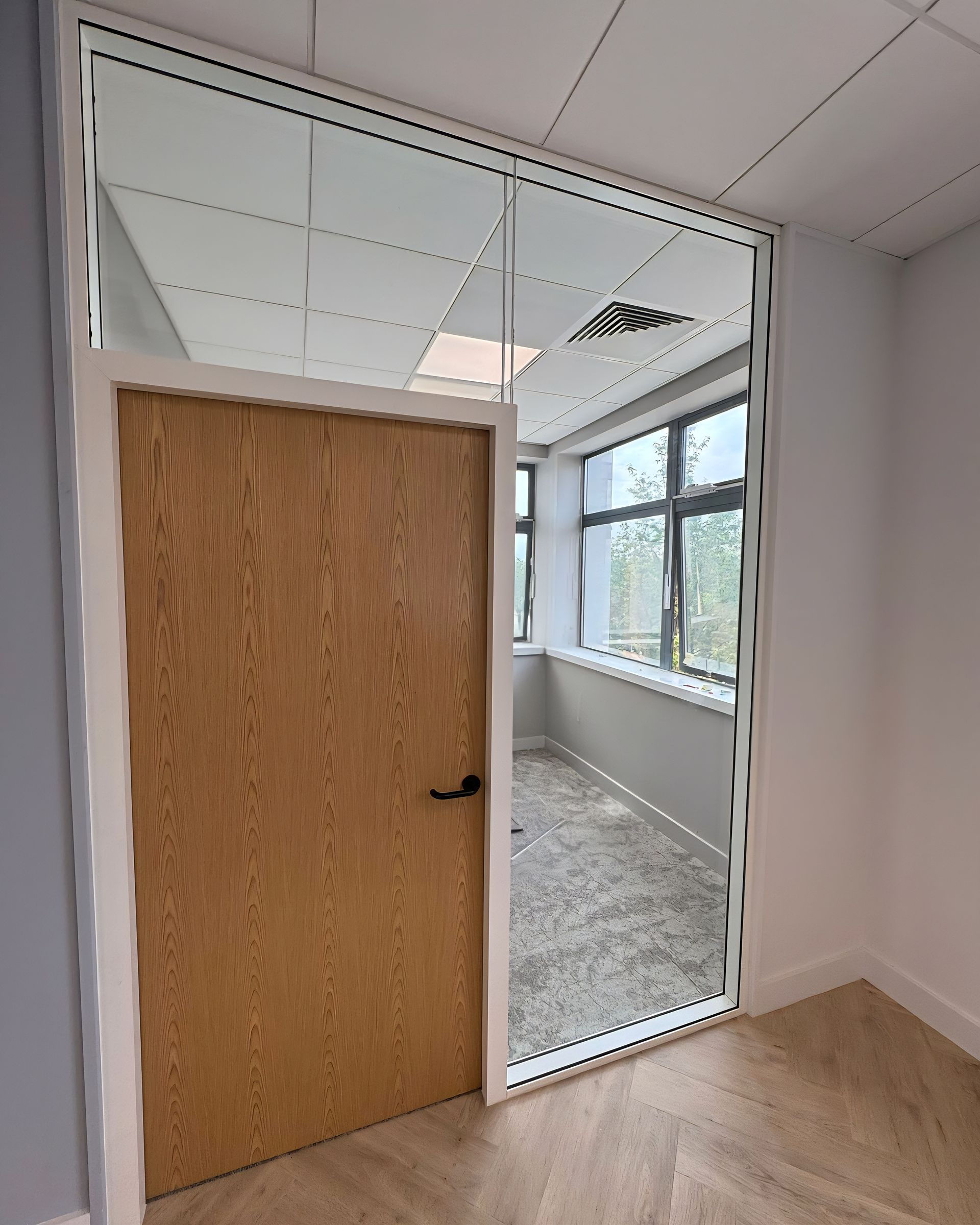 Professional glass partition system with framed oak doors for commercial office fit out in Teesside