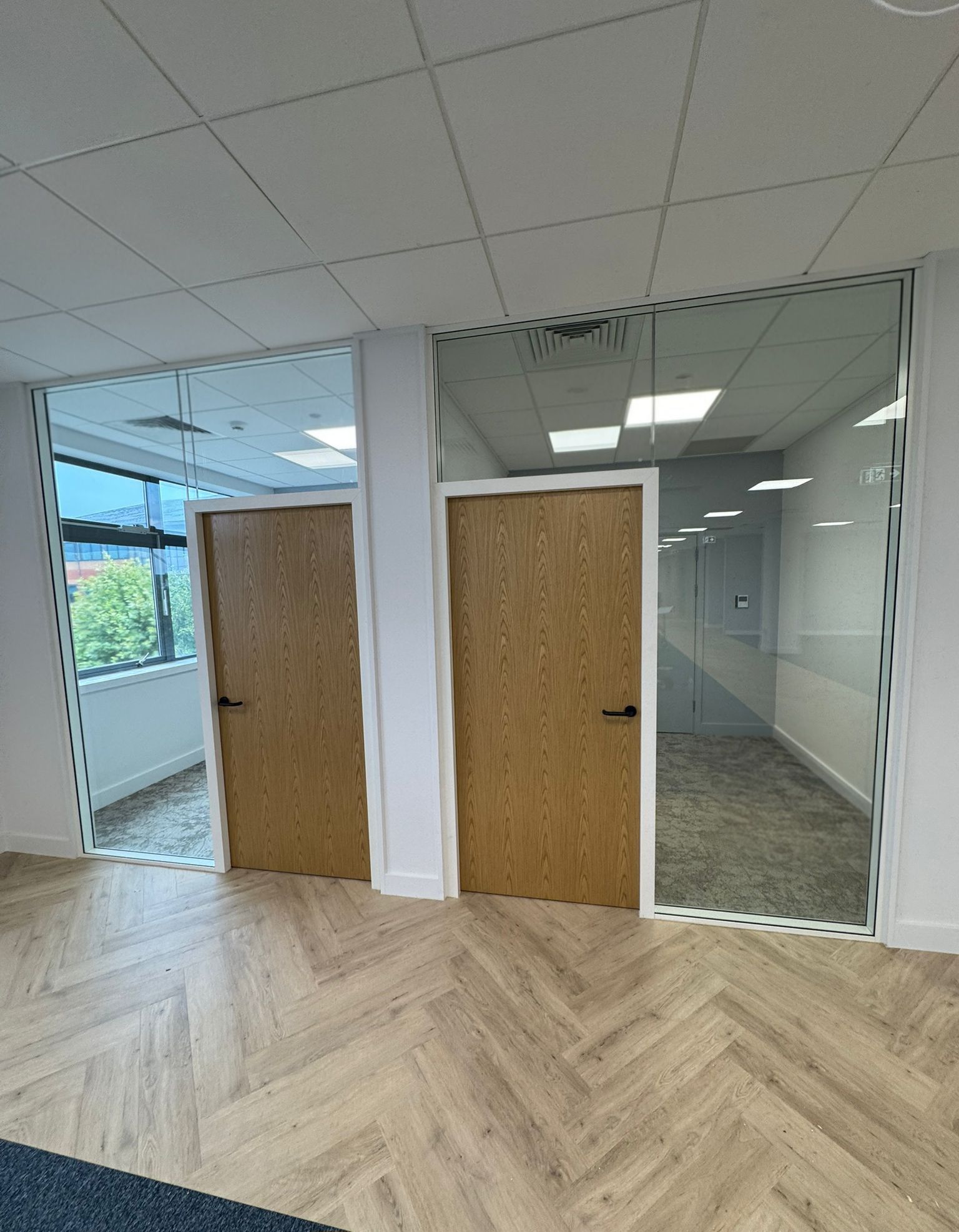 Clear Divide glass office partitions installation with oak flush doors in Teesside