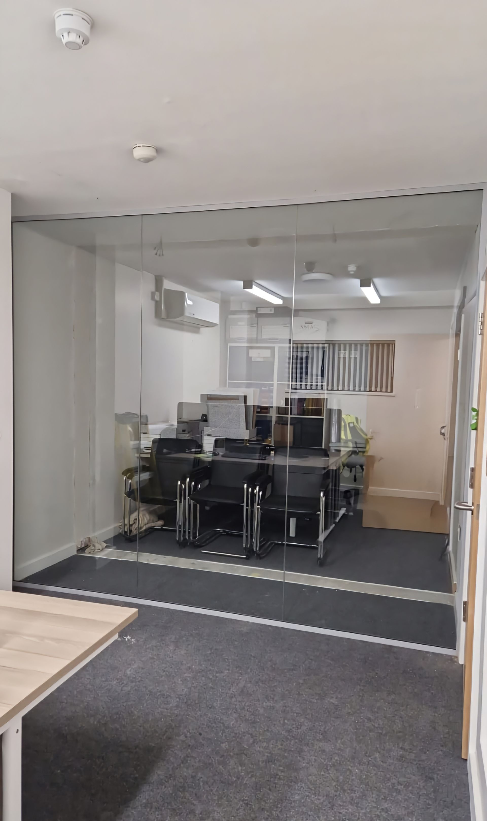 Minimalist frameless glass wall installed in dockside commercial project