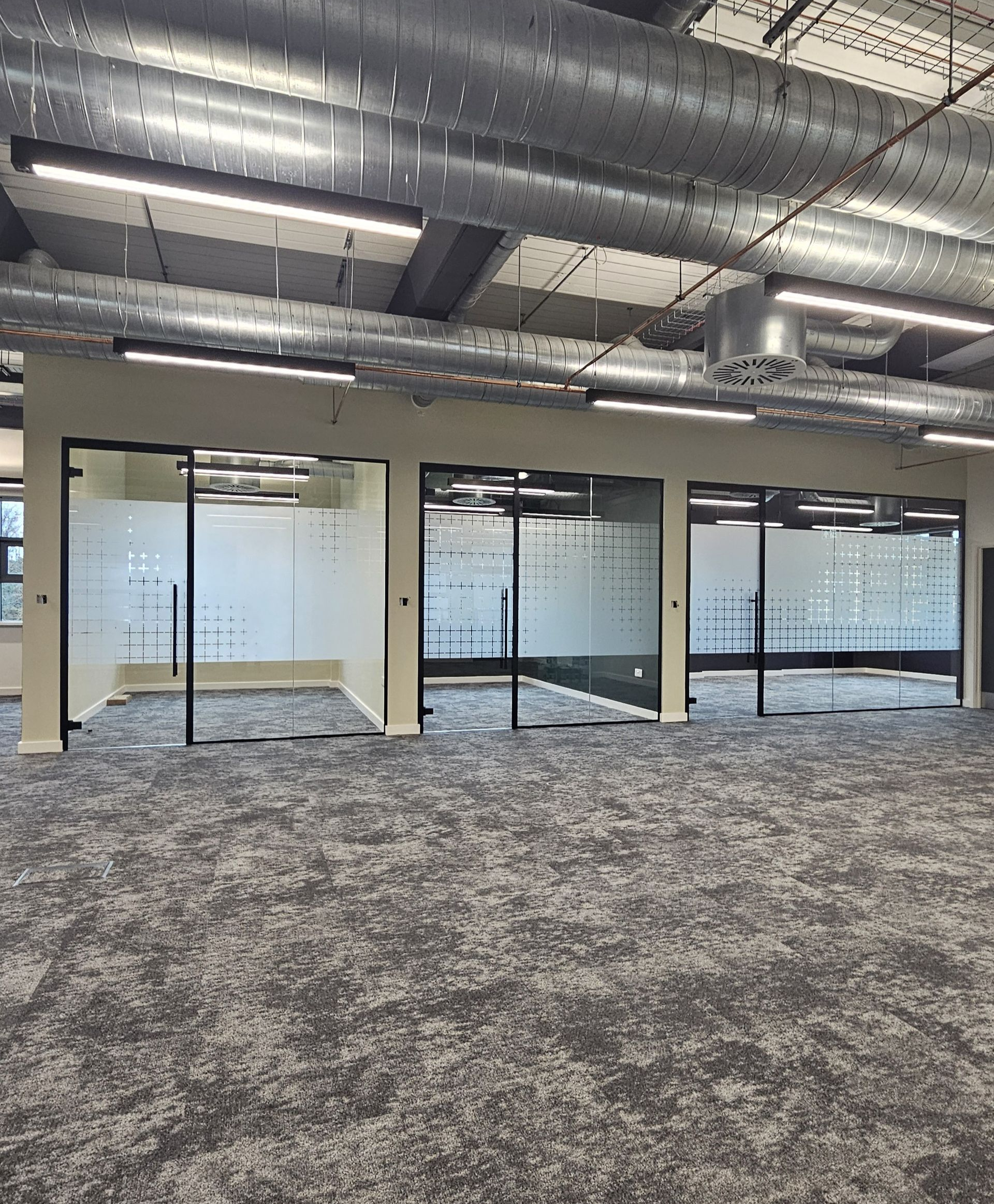 Single glazed office partitions installed with bespoke manifestation in Newcastle