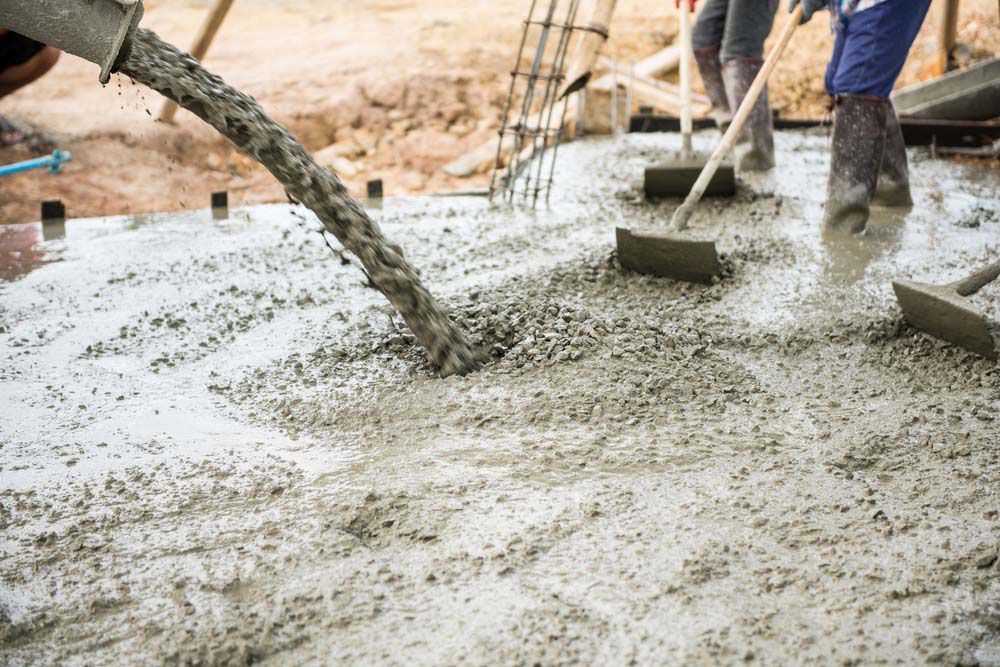 Concrete Being Poured on the Ground — NBM Constructions