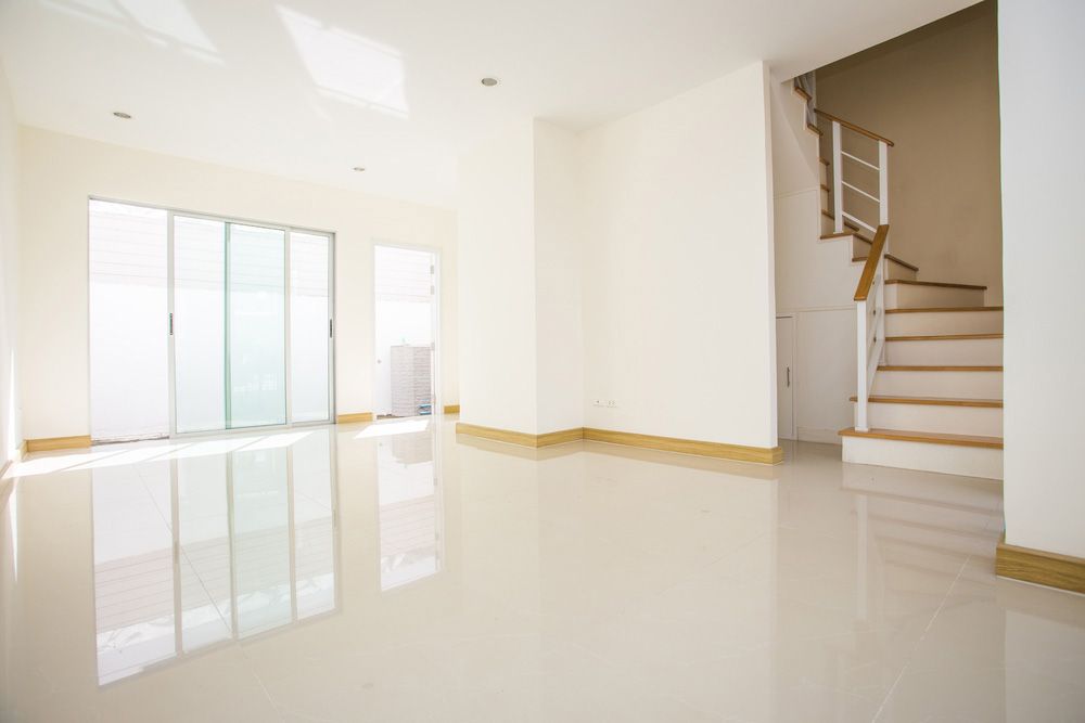 Empty Room with Staircase and Sliding Glass Doors — NBM Constructions