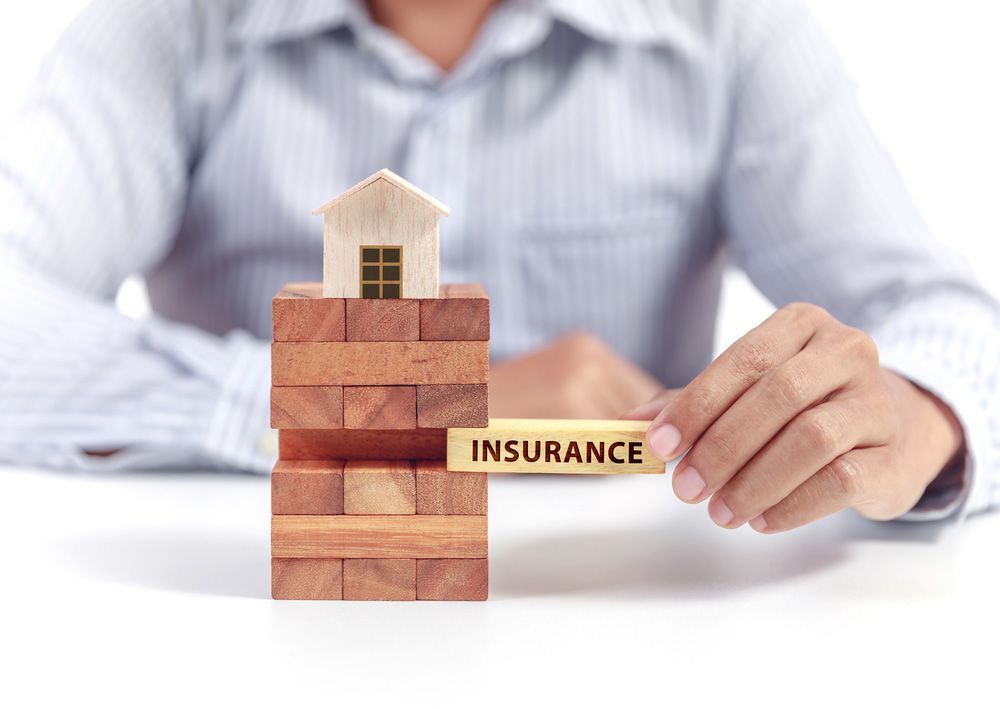 Wooden Block with the Word 'Insurance — NBM Constructions