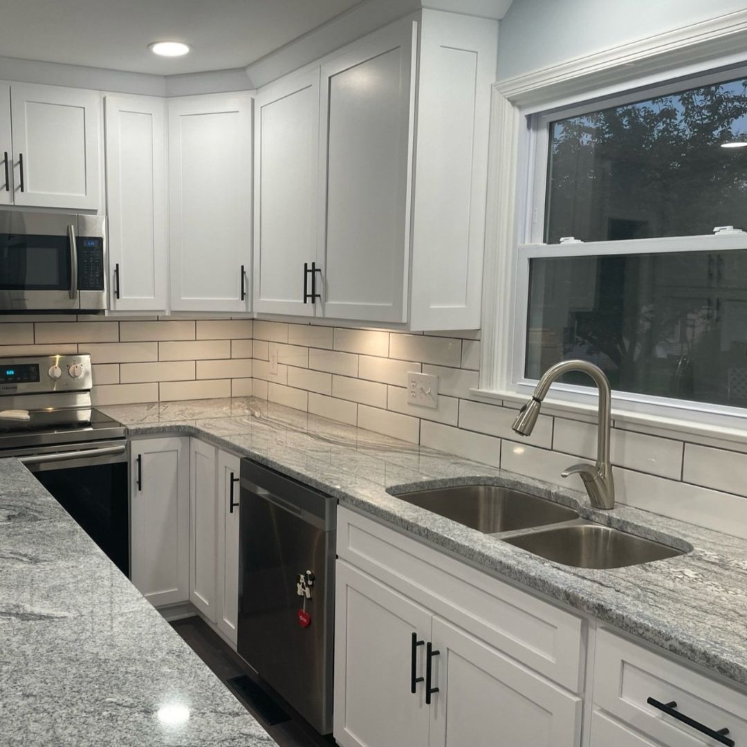 Different Angle of Stunning Kitchen with White Cabinets and Marble Tops