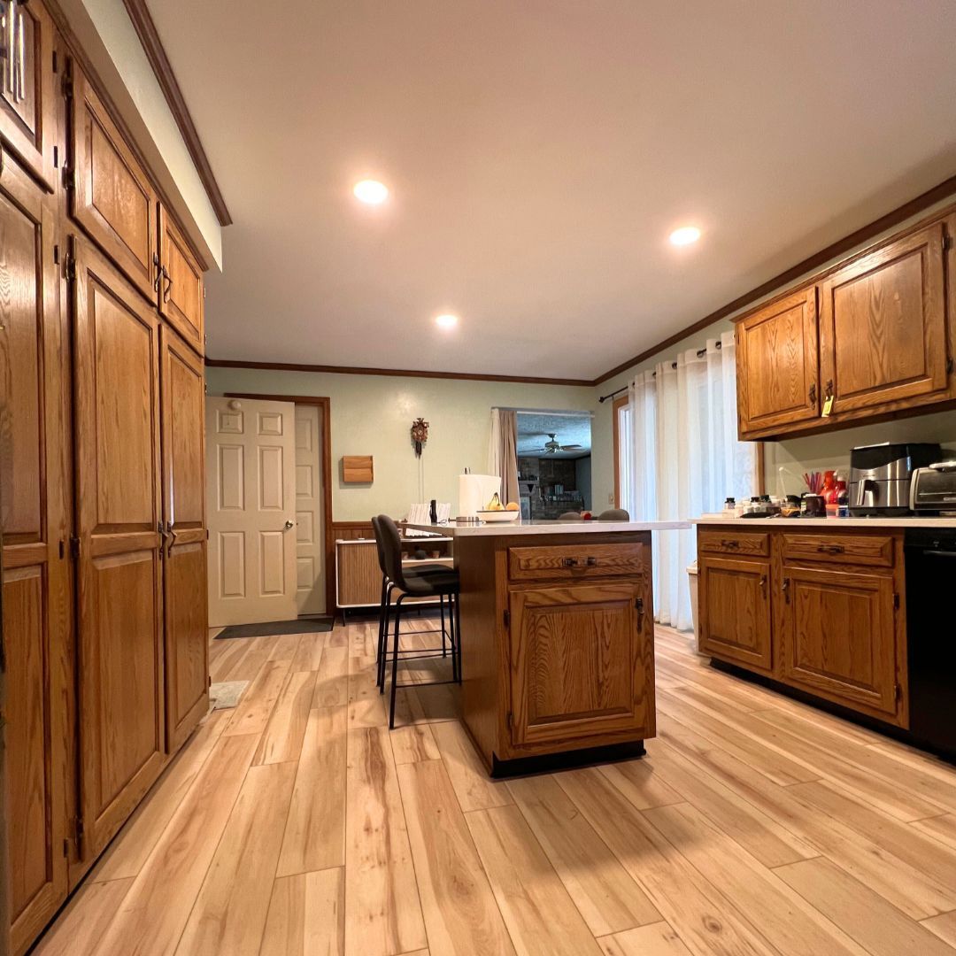 Kitchen with Warm Wood Custom Cabinets and New Flooring