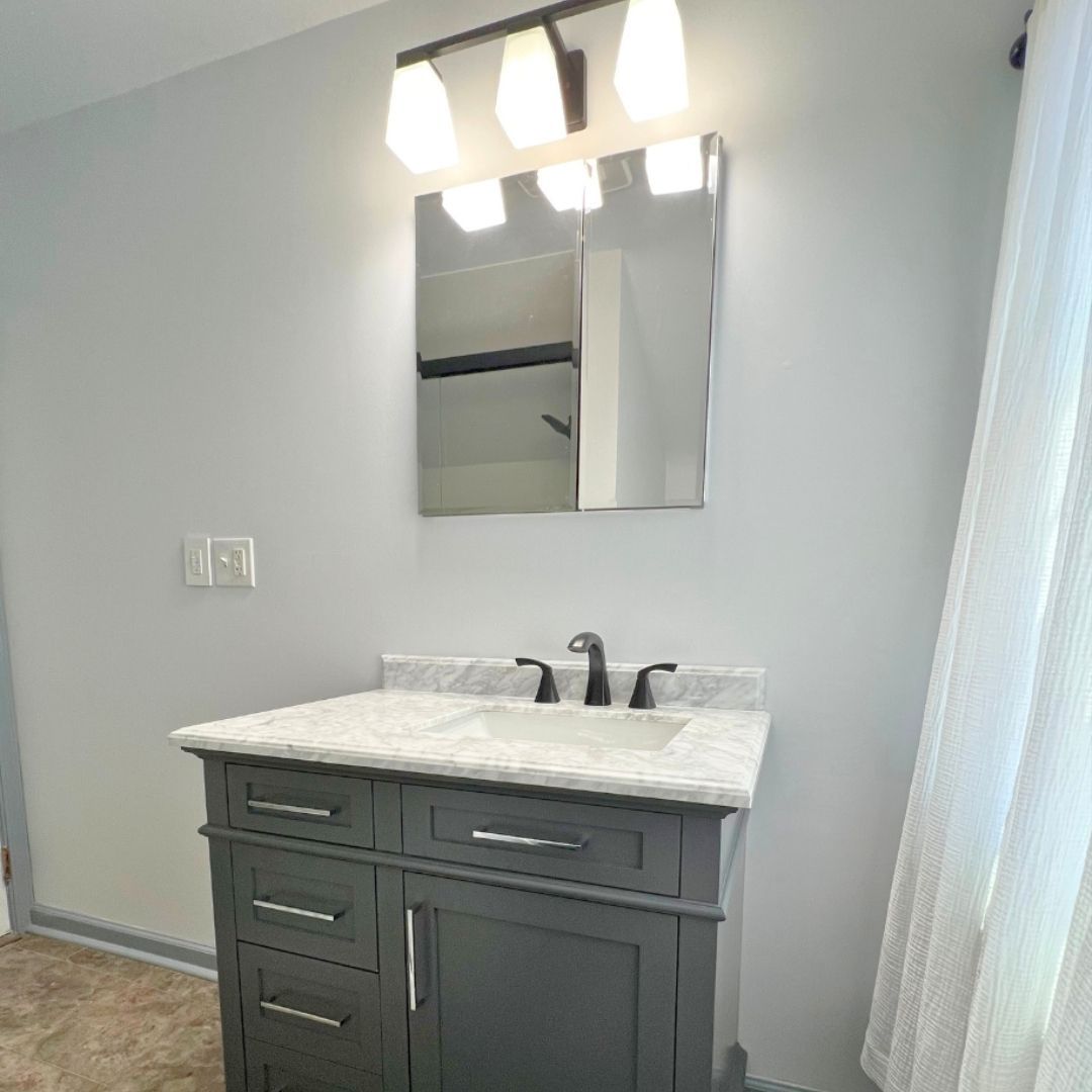 Bathroom Remodel in New Cumberland with New Vanity, Lighting, Flooring and Shower.
