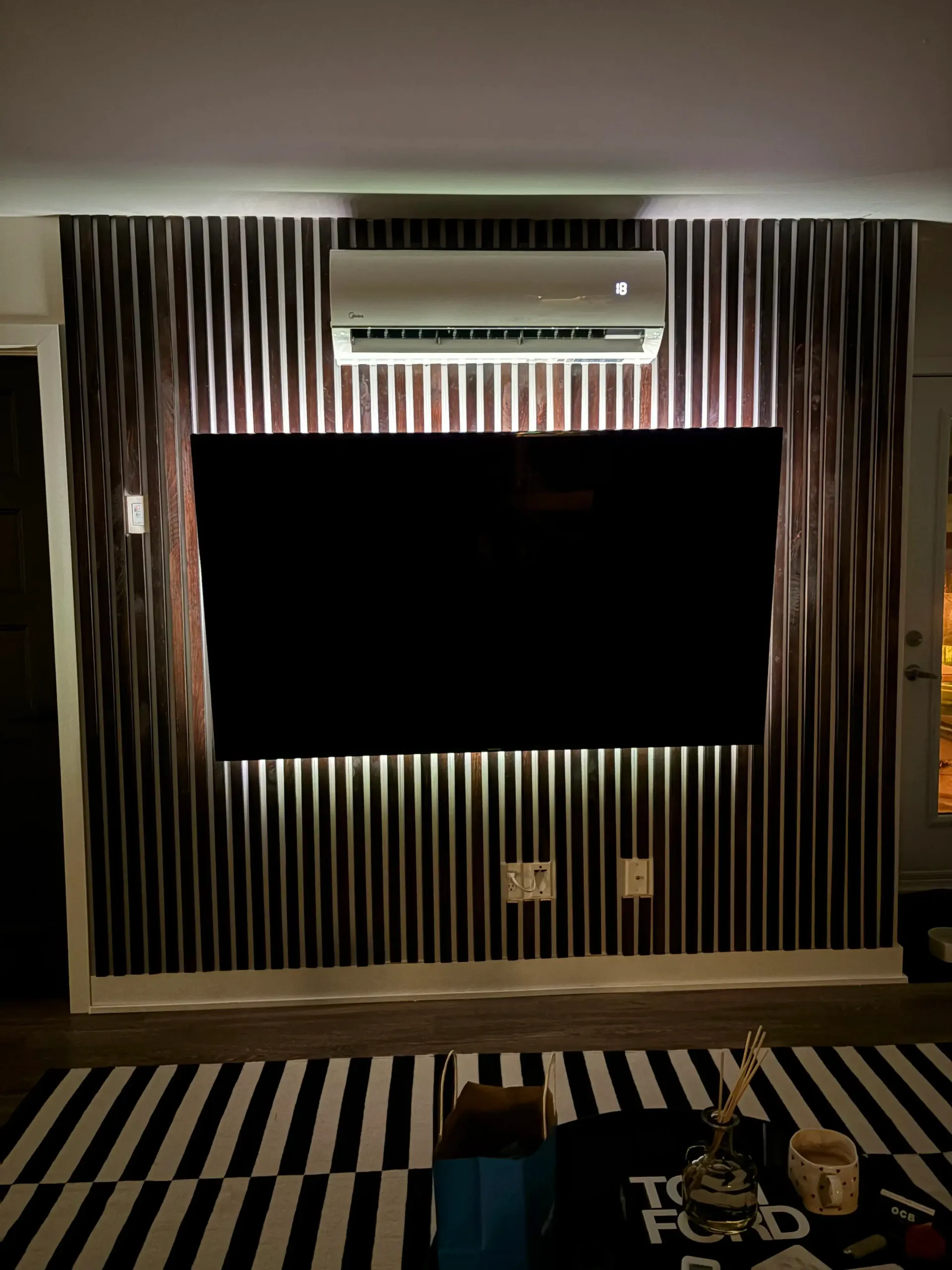 TV room wall with stained wood accent slats.