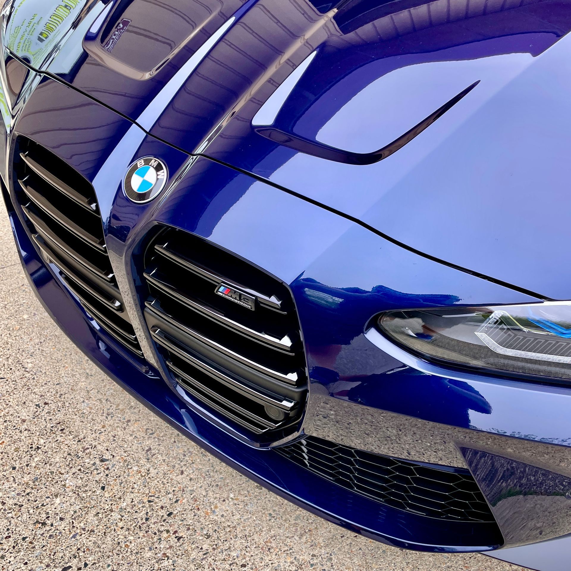 A close up of a side view mirror on a car in a garage.